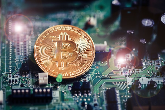 Bitcoin currency on electronic board background