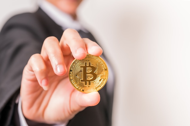 Bitcoin, Ethereum, Litecoin, Ripple. Women hold the cryptocurrency coin on hand