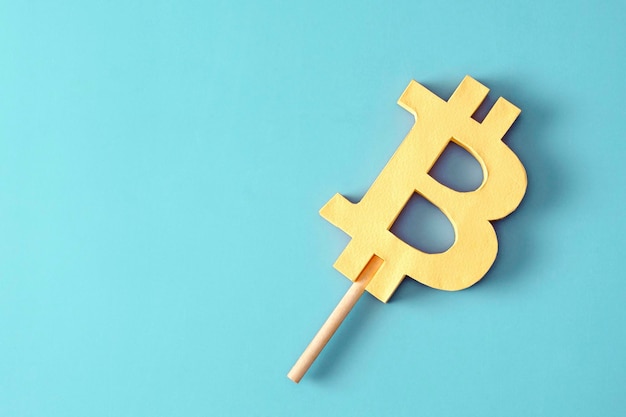 Bitcoin like ice cream on a stick minimal creative concept of profit and loss or success and risk in the cryptocurrency market with blockchain technology