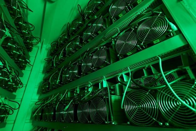 Bitcoin miners in large farm ASIC mining equipment on stand racks mine cryptocurrency in steel container Blockchain techology application specific integrated circuit rig Server room lights and fans