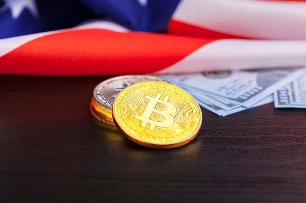 Bitcoin physical coins on American flag  with dollars