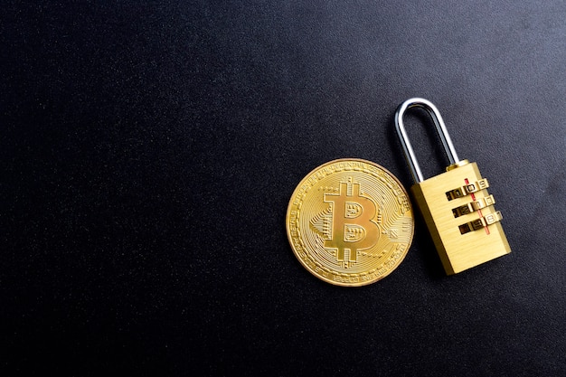 Bitcoin Security and insurance concept. cryptocurrency bitcoin with lock on black textured background