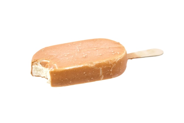 Bitten ice cream in caramel glaze on a wooden stick isolated on white