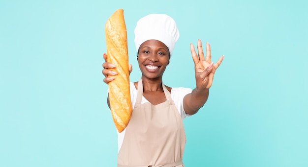 Black african american adult chef woman holding a bread baguette