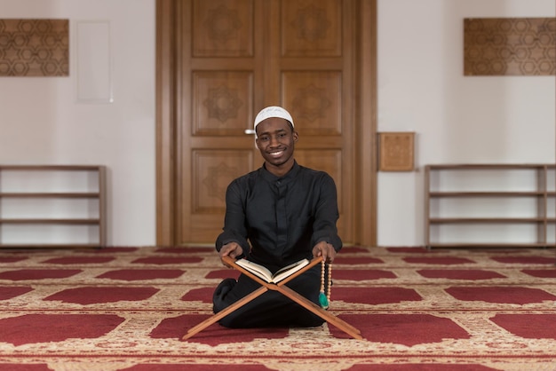 Black African Muslim Man Reading Holy Islamic Book Koran