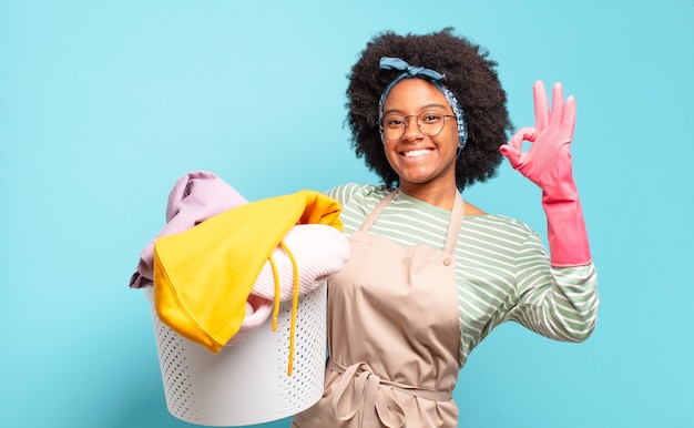 Black afro woman feeling happy, relaxed and satisfied, showing approval with okay gesture, smiling. housekeeping concept.. household concept