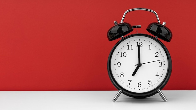 Black alarm clock on a red background