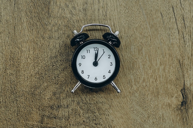 Black alarm clock on wood