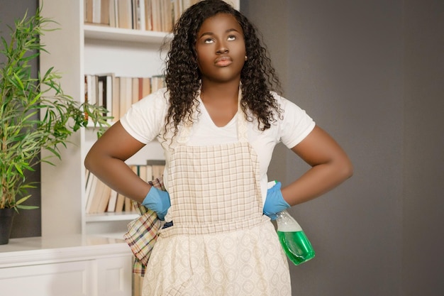 Black american woman with hands on hips planning how to do the best cleaning in her home closeup