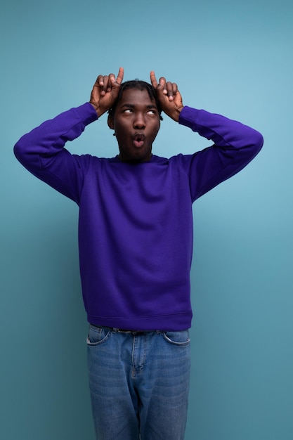 Black american young guy with dreadlocks makes a face