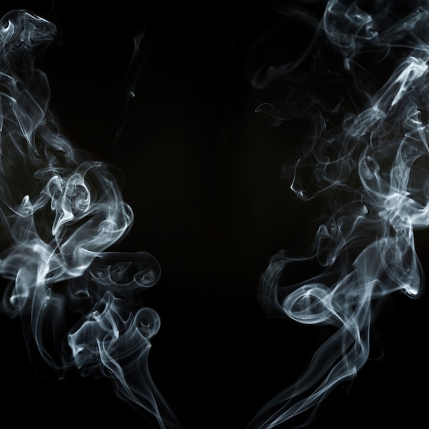 Black background with two smoke silhouettes in motion