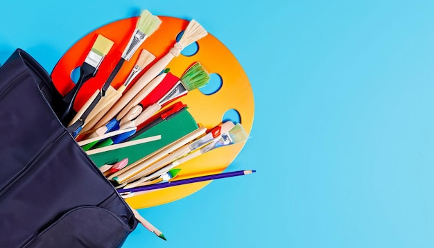 A black bag with colorful paint brushes and a black bag with a blue background.