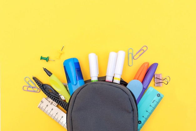 A black bag with a pencil case and a ruler on it.