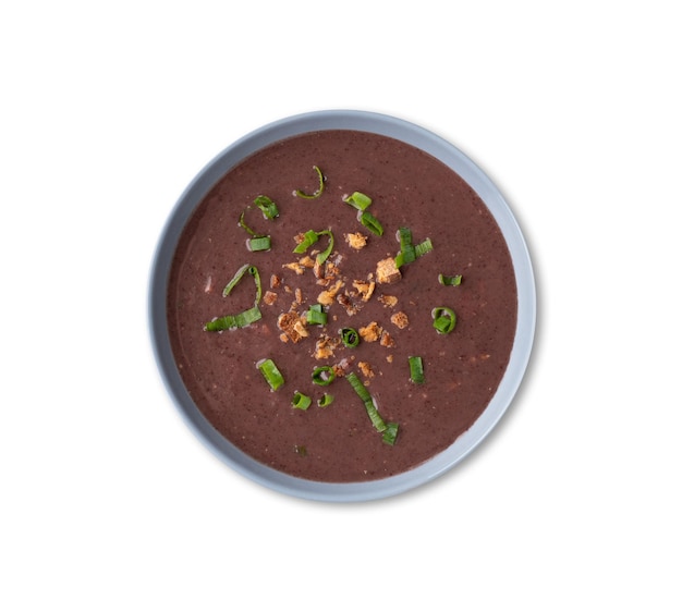 Black bean soup in a bowl isolated over white background