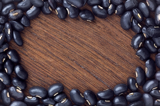 Black bean on wooden table. top view	