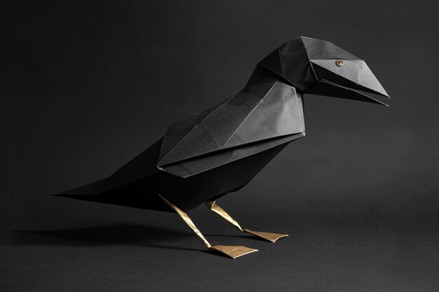 Photo a black bird made of paper