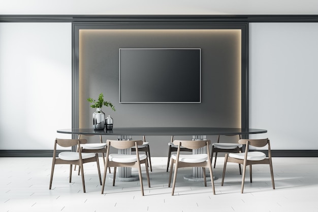 Black blank screen in the center of dark wall panel with lights around and big table with modern wooden chairs on ceramic floor tiles Mock up