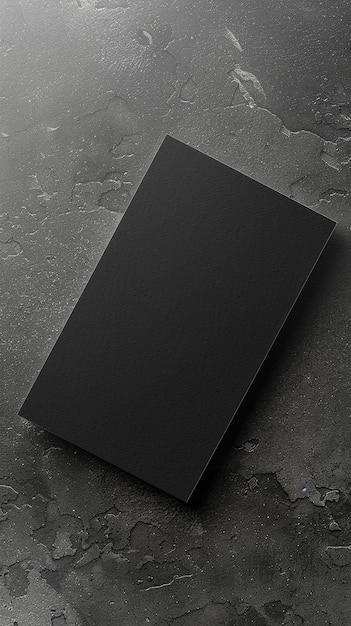 Photo a black book is laying on a marble surface