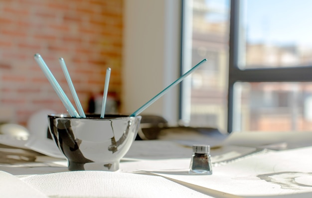 Black bowl with brushes at home.