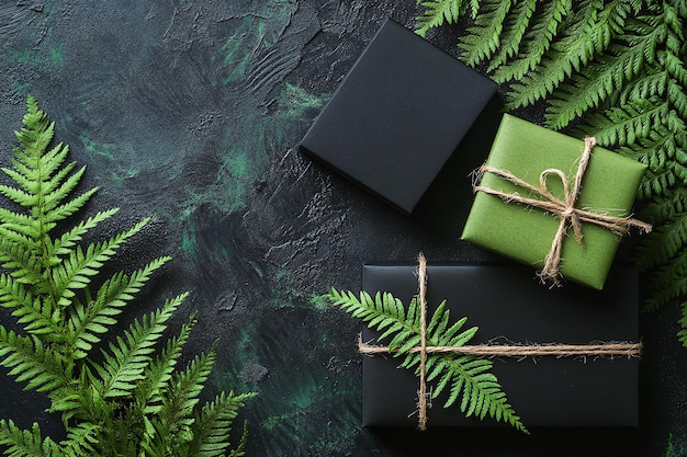 a black box with a green ribbon and a gift box on it