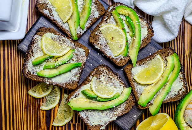 Black bread diet sandwich with avocado and lemon