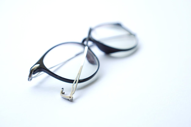 Black broken old glasses isolated on white