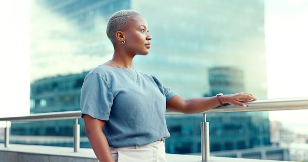 Black business woman in city on balcony and thinking for opportunity vision and professional mindset Female leader ceo and manager with skills and motivation for career goals as future leader