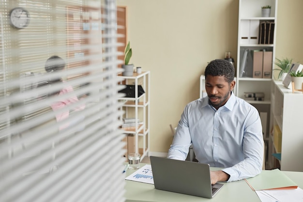 Black businessman using computer at desk