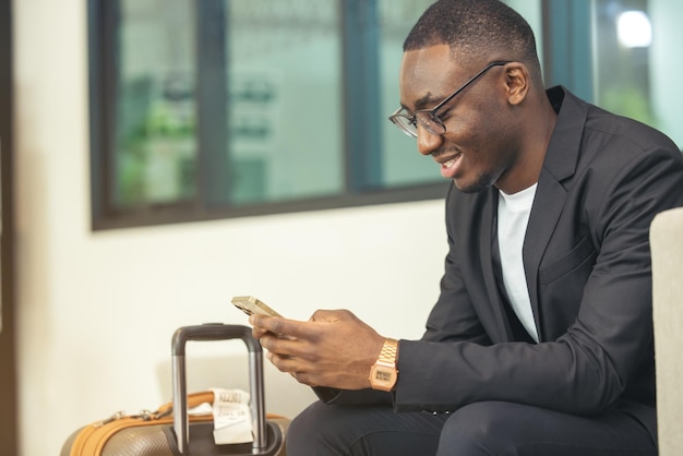 A black businessman works on his laptop in a cafe