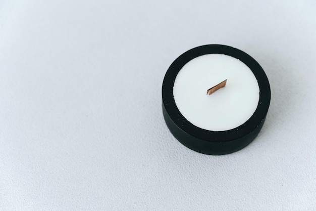 Black Candlestick Made of Plaster With Soy Wax on Light Background Like YinYang