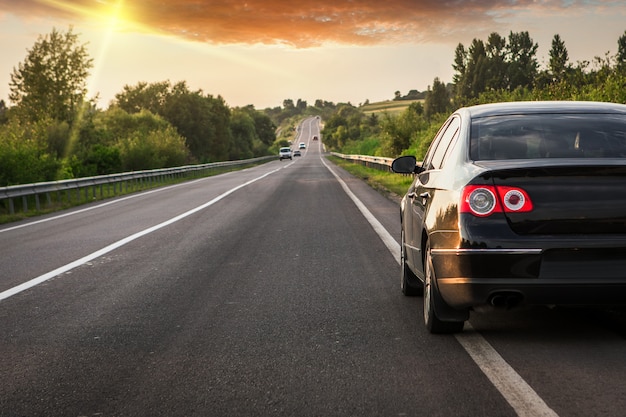 Black car on asphalt road