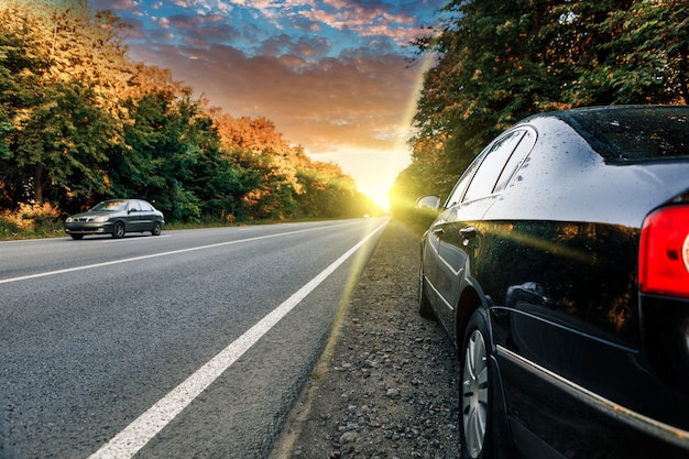 Black car on asphalt road