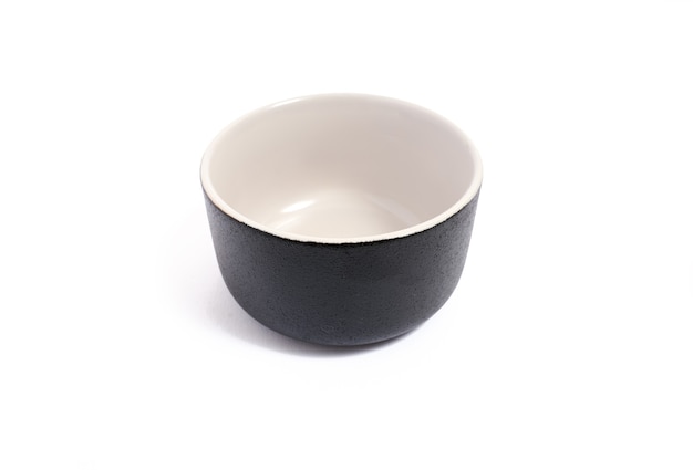 Black ceramic bowl isolated on white.