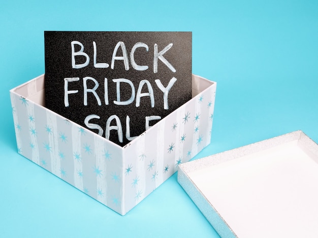 Black chalk board with chalk lettering black friday sale in a gift box