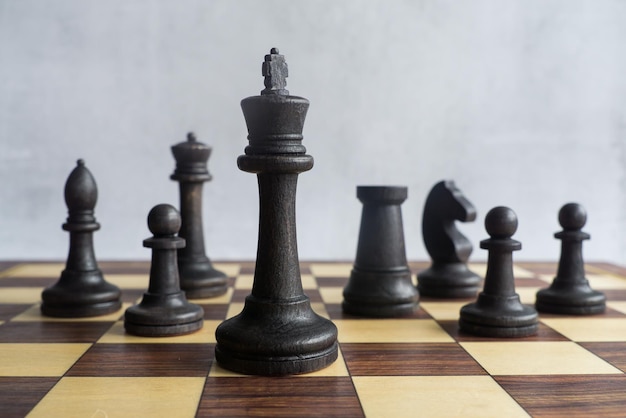 Black chess figures together on the chess board