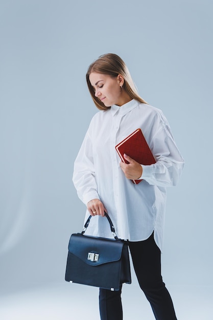 Black classic leather bag in a girl's hand Woman with luxury bag