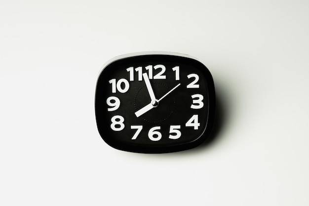 Black clock on white background.