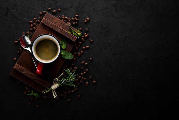 Black coffee in a cup On a black stone background Top view Free copy space