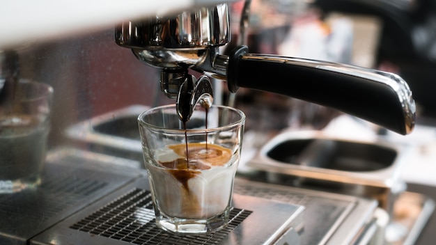 Black coffee with milk on coffee maker