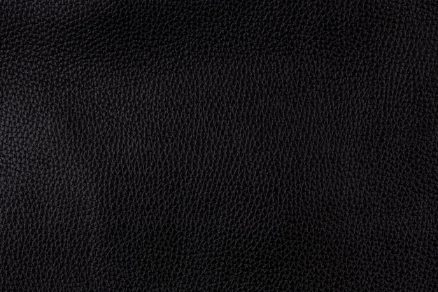 Black color textured smooth leather surface background, big grain