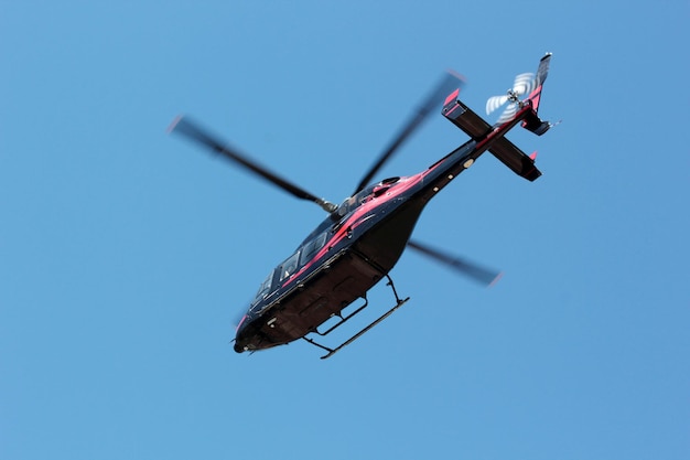 Black commercial helicopter in flight