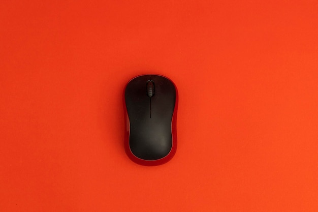 Black computer mouse on red background