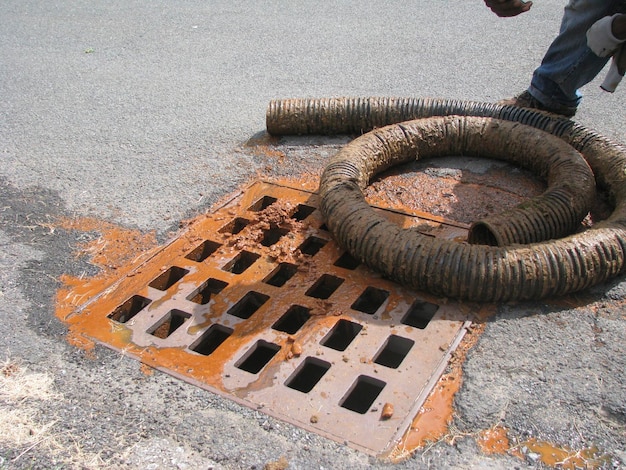 Black corrugated plastic pipe on ground. Pipes for use in outdoor Sewerage systems. Sewer problem