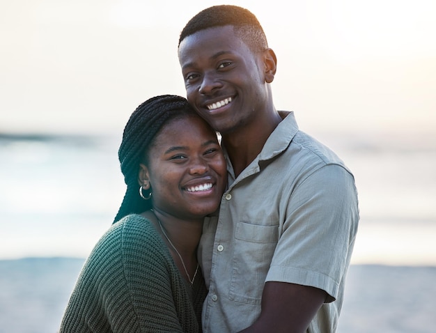 Black couple happy and portrait outdoor at the beach with love care and commitment Smile on face of young african man and woman together on vacation holiday or sunset travel adventure in Jamaica