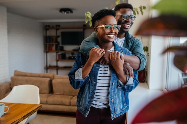 Black couple in love hugging at home