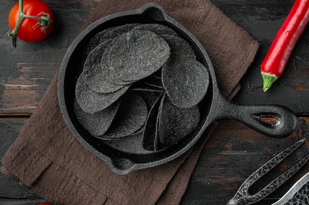 Black crispy potato chips set, top view flat lay