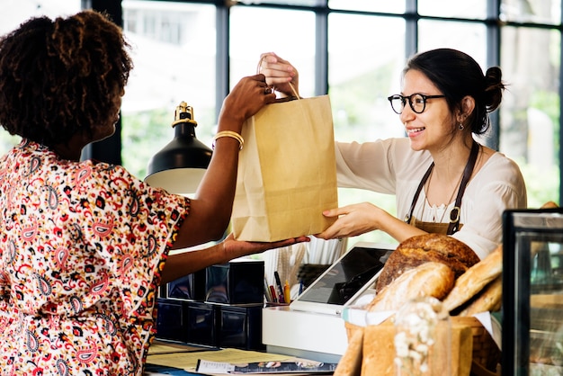 Black customer buying bakery products