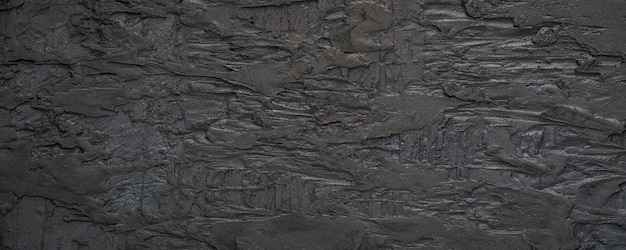 Black or dark gray grainy plaster texture background