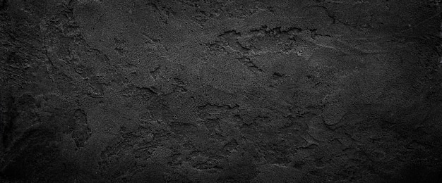 Black or dark gray rough grainy stone texture background