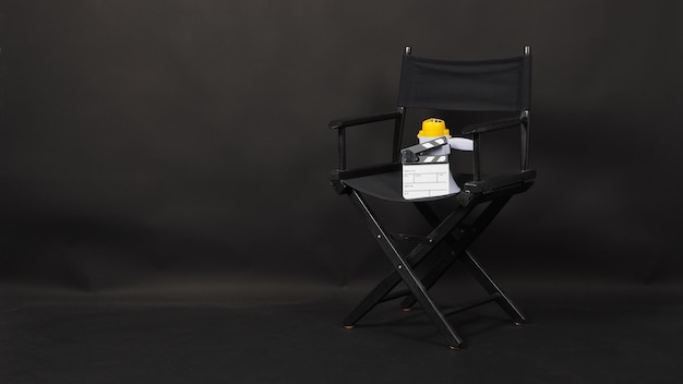 BLACK director chair with Clapperboard or movie Clapper board and megaphone on black background